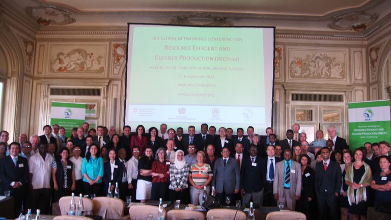 Conference participants in the hall in front of the screen
