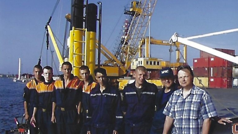 Expedition members in EMERCOM uniform on the deck of a vessel