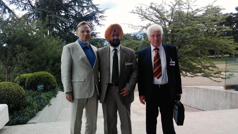 Dr A. A. Startsev with two congress participants outside a building